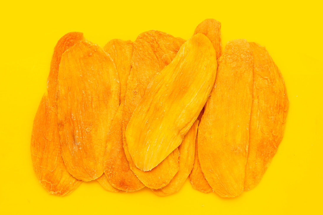 Dried mango on yellow background